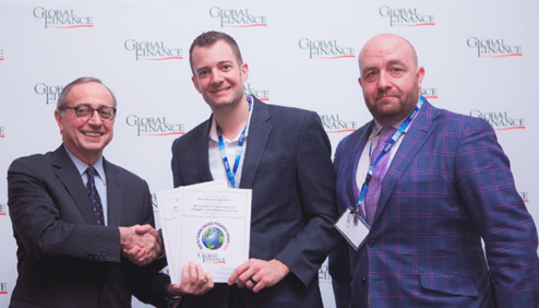 Joseph Giarraputo, Global Finance Publisher and President presents Best Customer Implementation award to Dustin Barney, AGCO and Matt Ford, PrimeRevenue