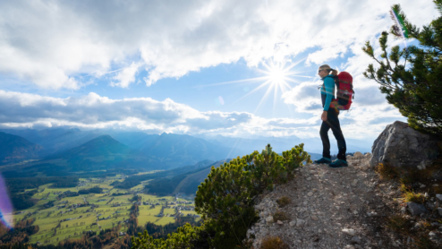 A woman on a mountain overlook seeing the skyline