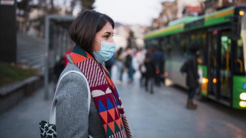 Woman with mask in a city